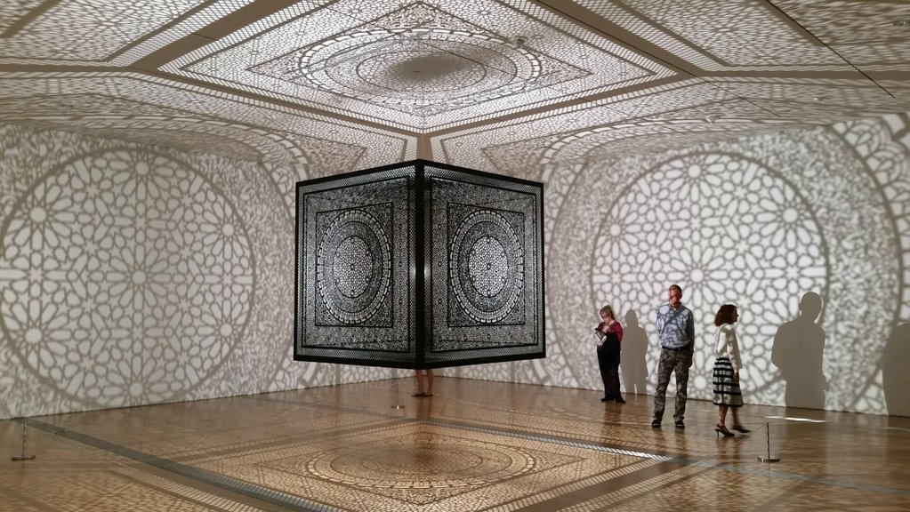 "Laser cut wooden cube suspended from the ceiling."